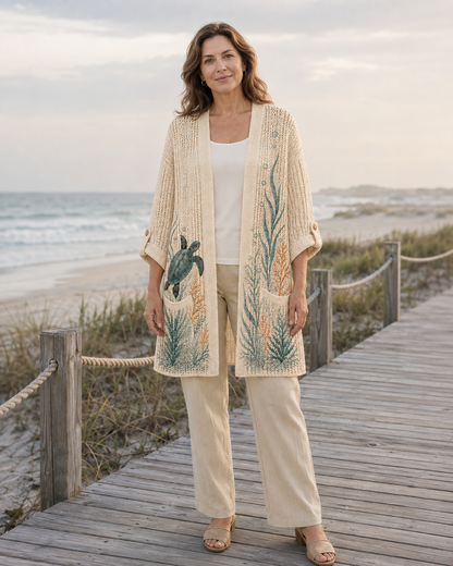 Woman wearing the Beige Coral Reef Sea Turtle Summer Cardigan on a beach boardwalk